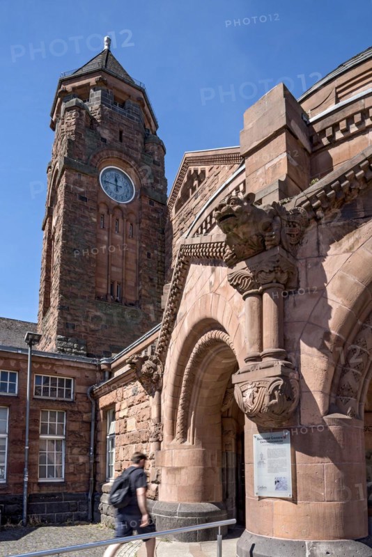 Historic Wilhelmine railway station, clock tower, pavilion with gargoyle, entrance to the station building, neo-Romanesque and Art Nouveau, red sandstone, cultural monument, listed building, Giessen, Giessen, Hesse, Germany, Europe