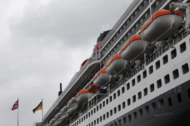 Side view of a cruise ship Queen Mary 2, with lined up lifeboats and flags, Hamburg, Hanseatic City of Hamburg, Germany, Europe