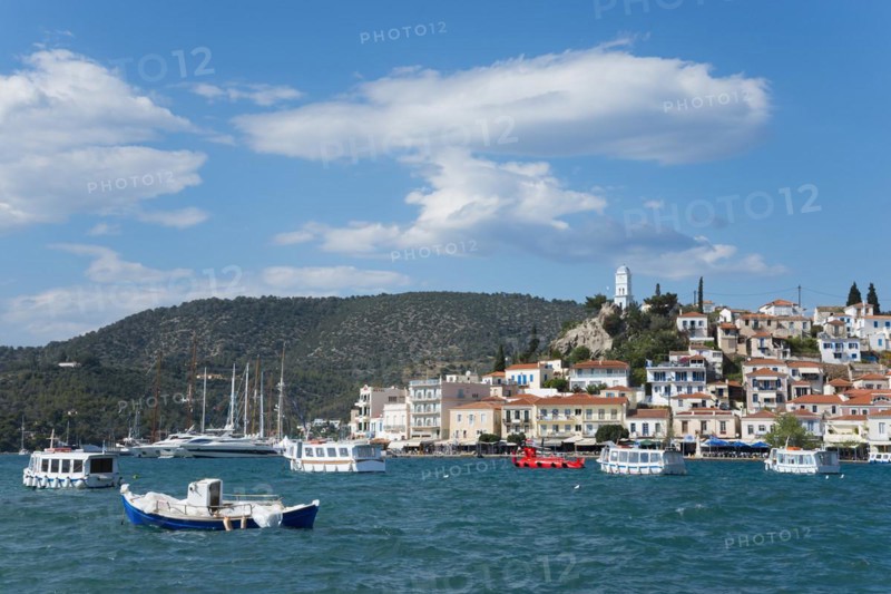 View of a picturesque coastal town with colourful boats on clear blue water under a partly cloudy sky, view from Galatas, Argolis, to Poros, Poros Island, Saronic Islands, Peloponnese, Greece, Europe
