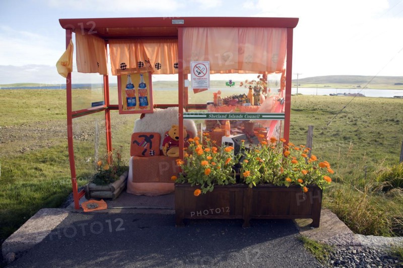 Orange colour theme decorated bus shelter, Haroldswick, Unst, Shetland Islands, Scotland, United Kingdom, Europe