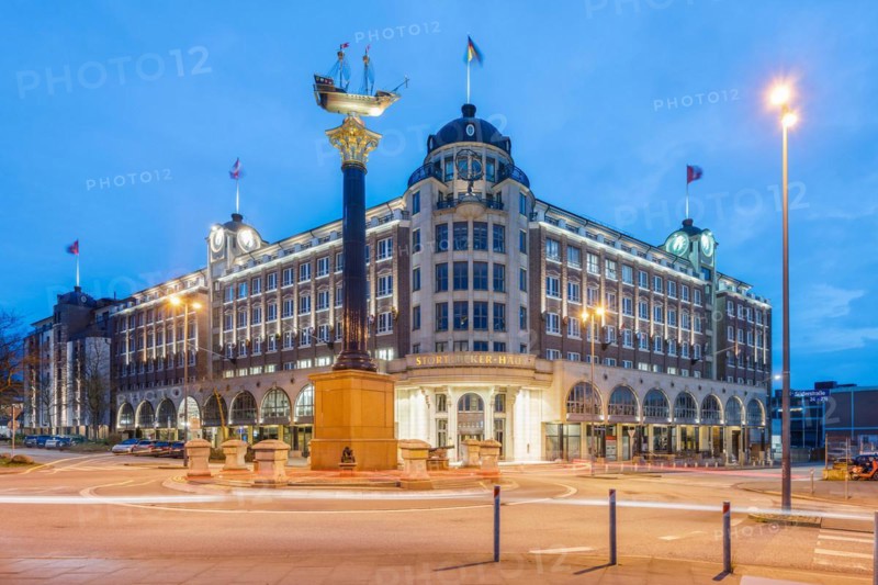 Stoertebeker House at the Blue Hour with granite column and ship, which is a replica of Stoertebeker's cog, Hamburg, Germany, Europe
