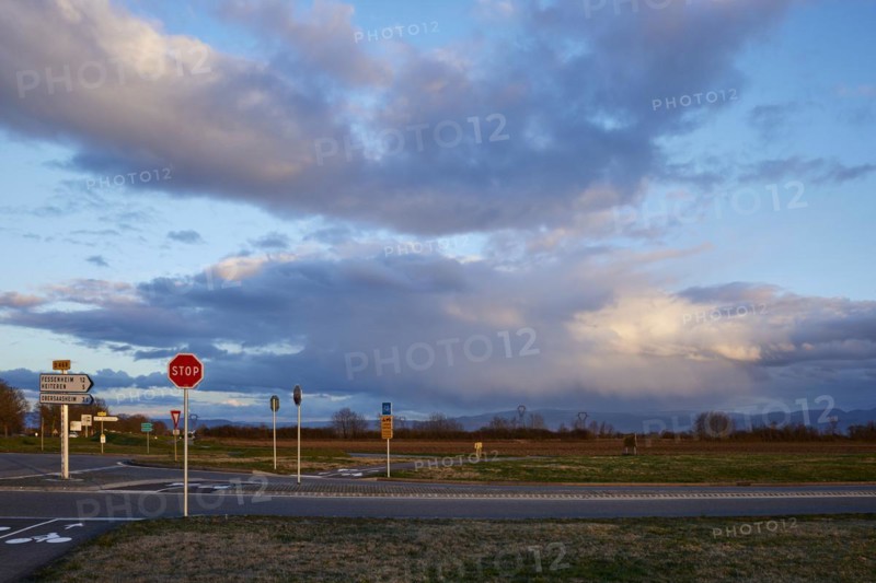 Weather change with mighty light to grey-blue clouds illuminated by the evening sun over the Black Forest as seen from Algolsheim, Haut-Rhin, Grand Est, France, Europe