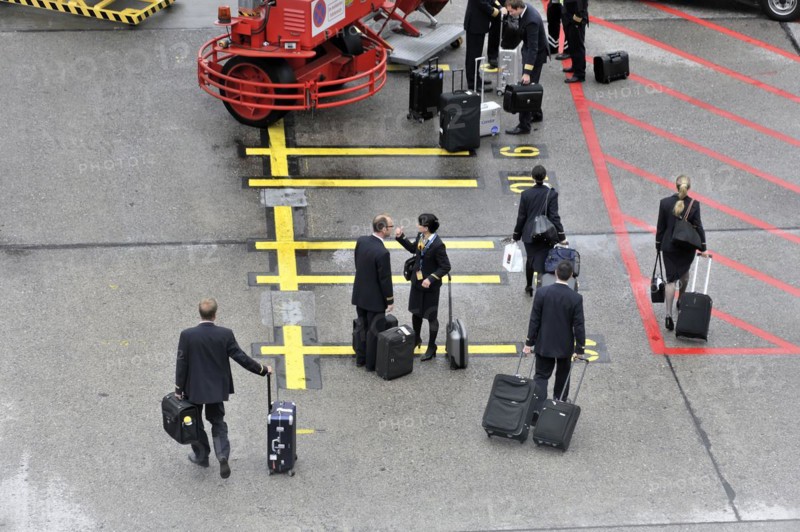 Crew members with wheeled suitcases walking down an aeroplane staircase, Hamburg, Hanseatic City of Hamburg, Germany, Europe