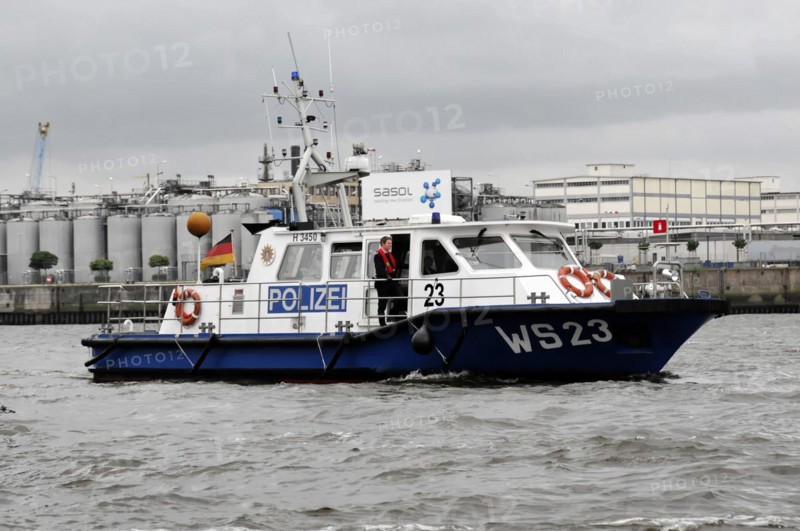 Police boat on the water with crew and cloudy sky in the background, Hamburg, Hanseatic City of Hamburg, Germany, Europe