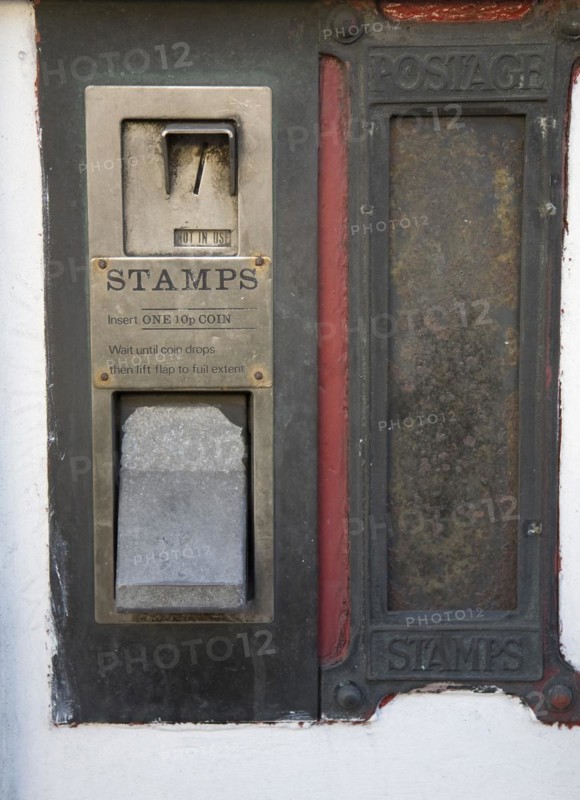 Old disused stamp vending machine and post box, England, UK