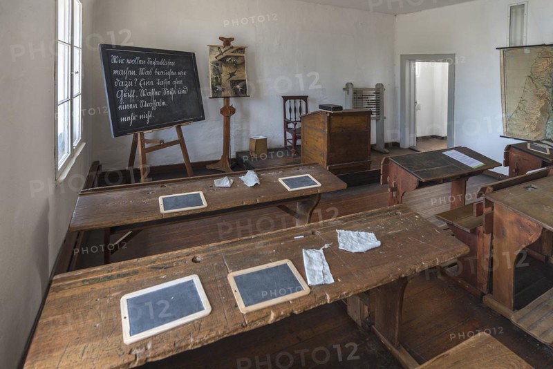 Chalkboards and blotting cloths on the school desks, blackboard and teacher's desk in a 19th century classroom, Open-Air Museum of Folklore Schwerin-Muess, Mecklenburg-Vorpommerm, Germany, Europe