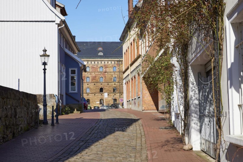 Alley Martinikirchhof with cobblestones and lantern in the city centre of Minden, Muehlenkreis Minden-Luebbecke, North Rhine-Westphalia, Germany, Europe