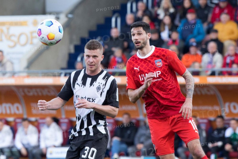 Football match, Tim KLEINDIENST 1.FC Heidenheim right and Nico ELVEDI Borussia Moenchengladbach with his eyes fixed on the ball, football stadium Voith-Arena, Heidenheim