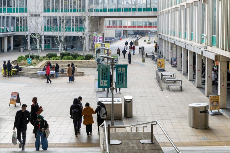 Students walking in campus square area, University of Essex, Colchester, Essex, England, UK