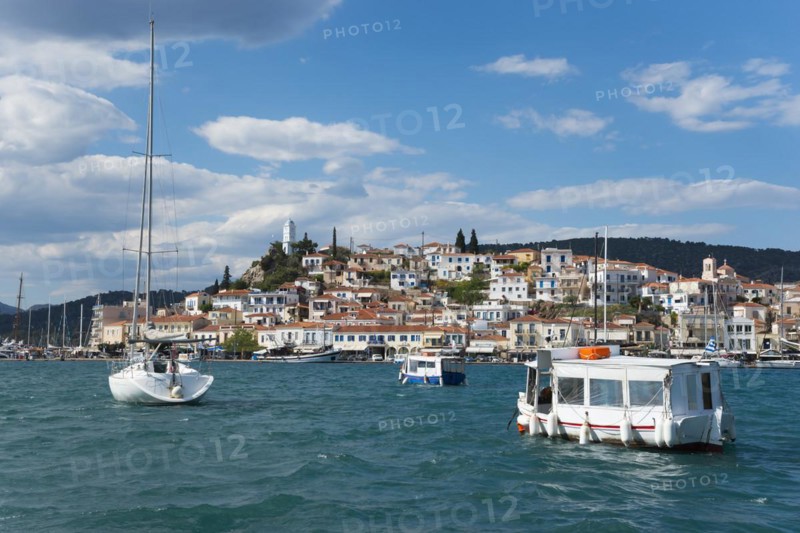 View over a busy harbour with boats and clear sky over a traditional coastal town, view from Galatas, Argolis, to Poros, Poros Island, Saronic Islands, Peloponnese, Greece, Europe