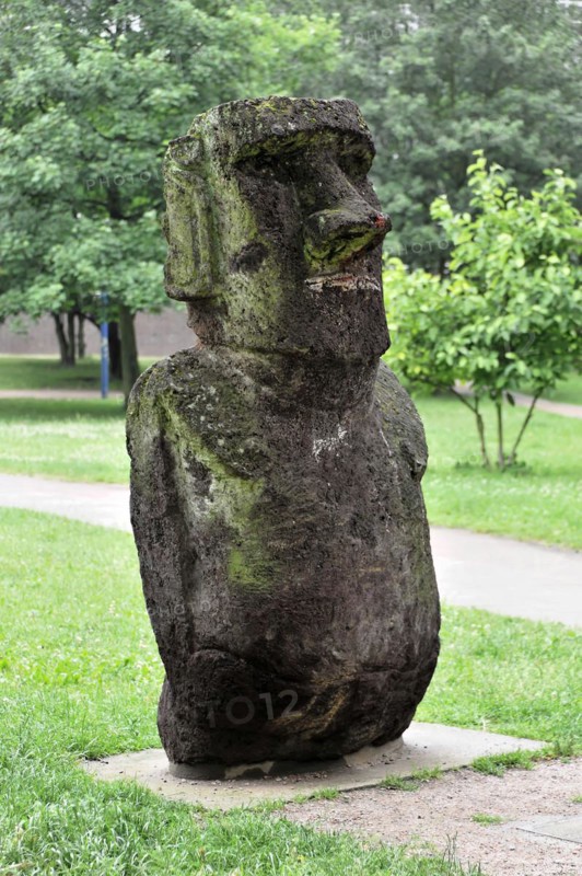 A moss-covered stone sculpture, similar to the Moai from Easter Island, in the park, Hamburg, Hanseatic City of Hamburg, Germany, Europe