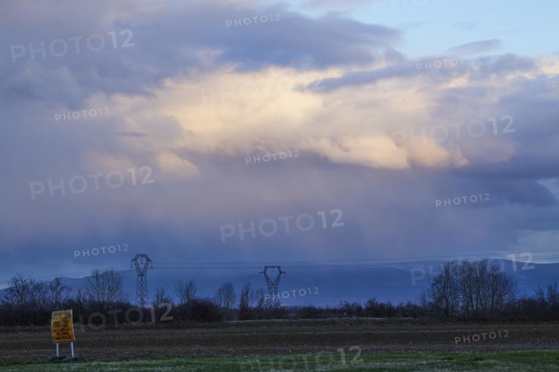 Weather change with mighty light to grey-blue clouds illuminated by the evening sun over the Black Forest as seen from Algolsheim, Haut-Rhin, Grand Est, France, Europe