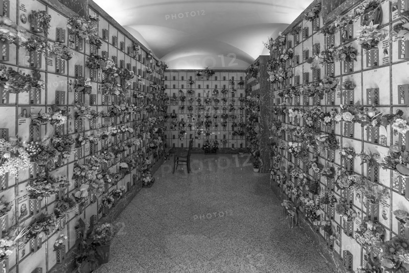 Graves with floral decorations in a hall at the Monumental Cemetery, Cimitero monumentale di Staglieno), Genoa, Italy, Europe