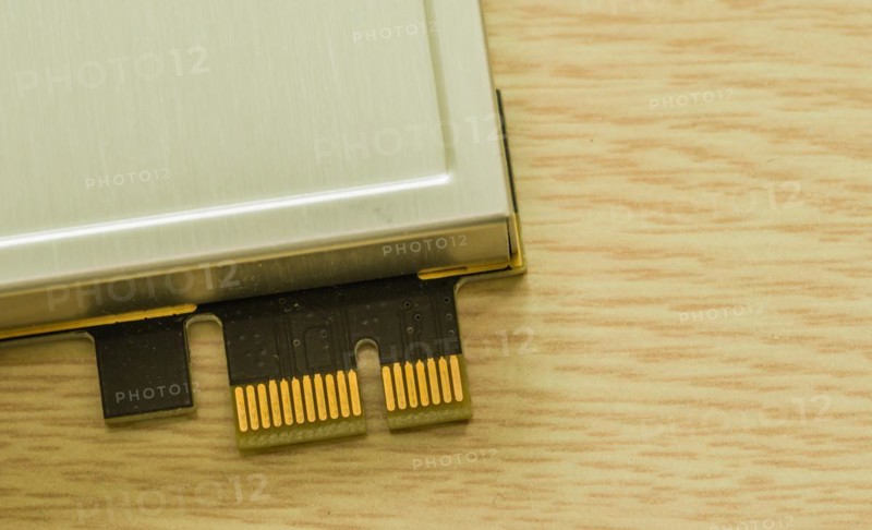 A dongle device with gold contacts lying next to a beige surface, in South Korea