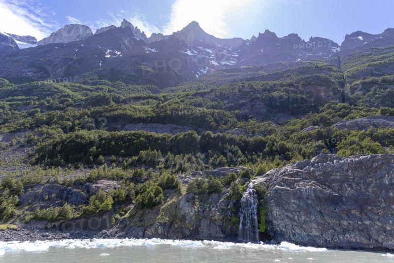 Waterfall, floating ice, mountain range, Andes, Lago Grey, Torres del Paine National Park, Parque Nacional Torres del Paine, Cordillera del Paine, Towers of the Blue Sky, Region de Magallanes y de la Antartica Chilena, Ultima Esperanza Province, UNESCO Biosphere Reserve, Patagonia, End of the World, Chile, South America