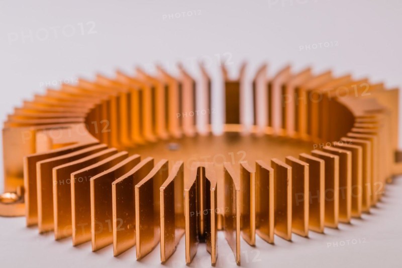 Closeup of round copper computer heat sink fins on white background