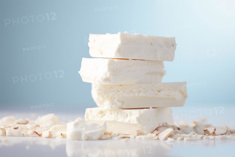 STack of white nougat on pastel blue studio background. KI generiert, generiert, AI generated