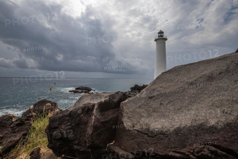 Le Phare du Vieux-Fort, white lighthouse on a cliff. Dramatic clouds with a view of the sea. Pure Caribbean on Guadeloupe, French Antilles, France, Europe