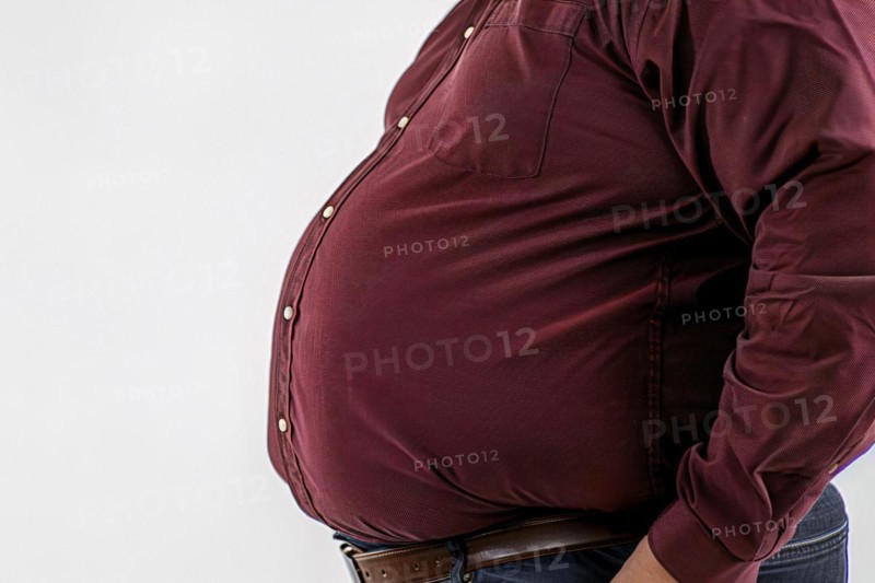 Close up of fat belly of heavily obese man in red shirt on white background. KI generiert, generiert, AI generated
