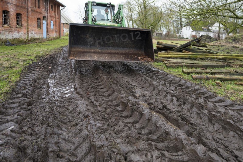 Tractor with tyre tracks on soaked ground on a farm, Othenstorf, Mecklenburg-Vorpommern, Germany, Europe