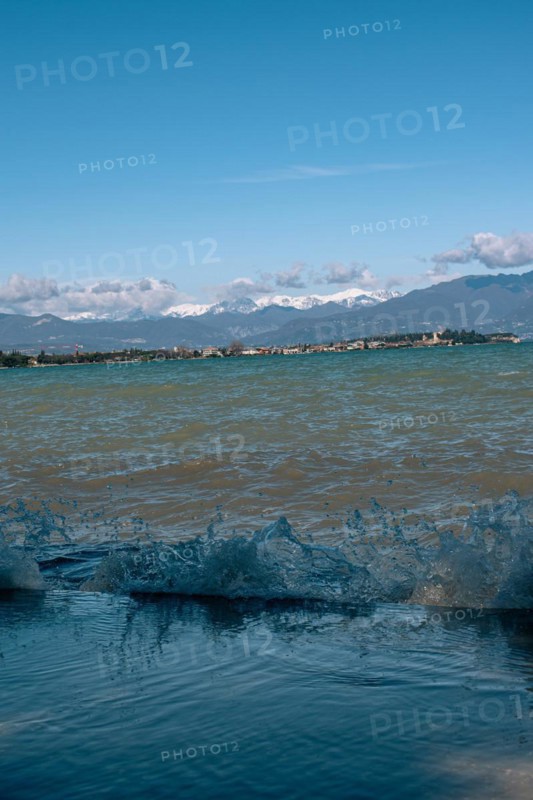 Splashing waves hitting the shore of Lake Garda, Sirmione, Lake Garda, Italy, Europe