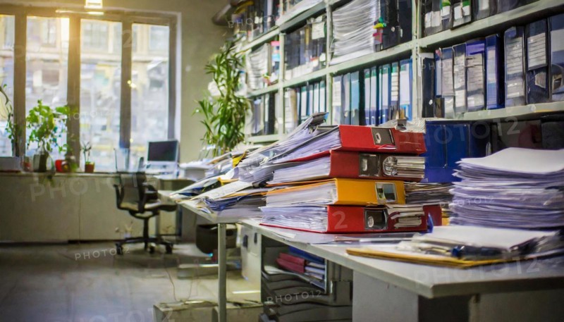 A busy office full of piles of documents and folders on shelves with a focus on organisation, symbol bureaucracy, AI generated, AI generated
