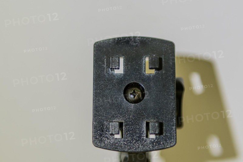 Closeup of car navigation mounting plate and its shadow on white background