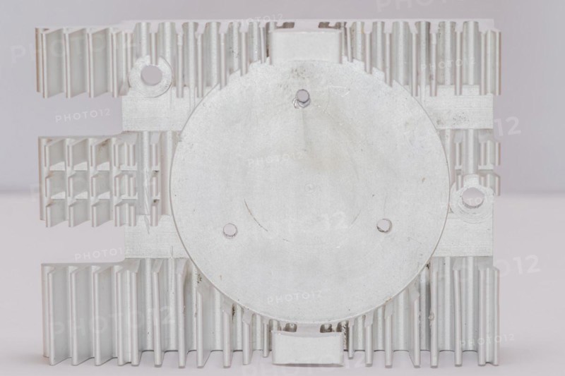 Closeup of fins and fan mounting surface of rectangle aluminum heat sink on white background