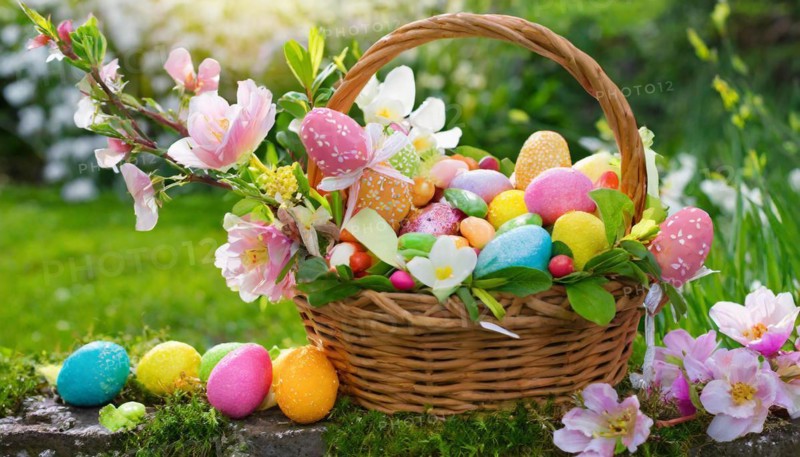 Spring-like Easter basket with colourful eggs and flower decorations in nature, Easter symbol, AI generated, AI generated