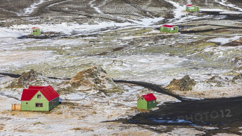 Green fishermen's huts with red roofs in a volcanic landscape, onset of winter, Fjallabak Nature Reserve, Sudurland, Iceland, Europe
