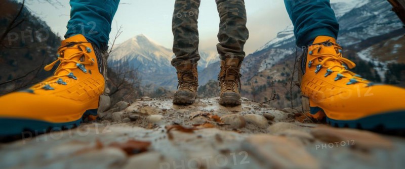 Adventurers' feet facing a majestic mountain range, AI generated
