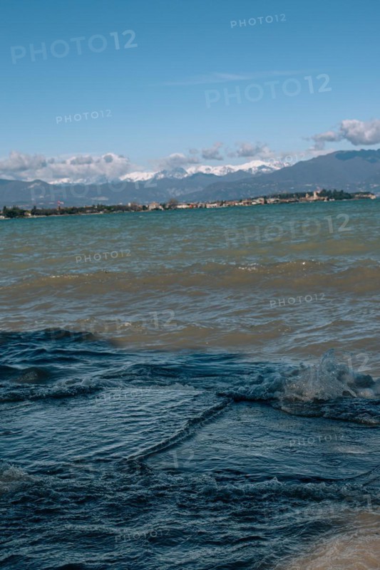 View over the wavy Lake Garda under a blue sky with clouds, Sirmione, Lake Garda, Italy, Europe
