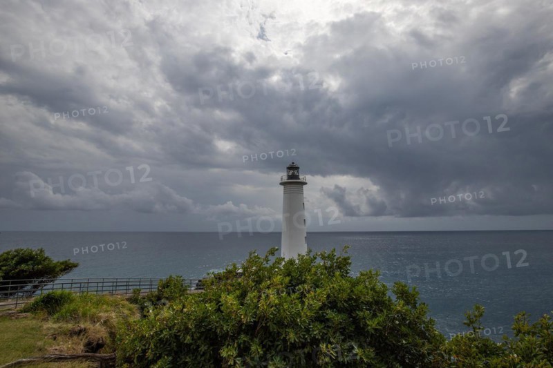 Le Phare du Vieux-Fort, white lighthouse on a cliff. Dramatic clouds with a view of the sea. Pure Caribbean on Guadeloupe, French Antilles, France, Europe