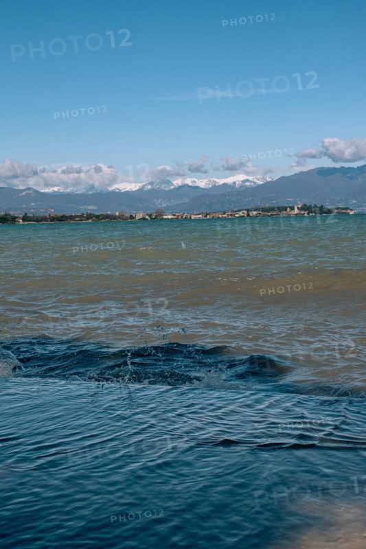 View over the wavy Lake Garda under a blue sky with clouds, Sirmione, Lake Garda, Italy, Europe