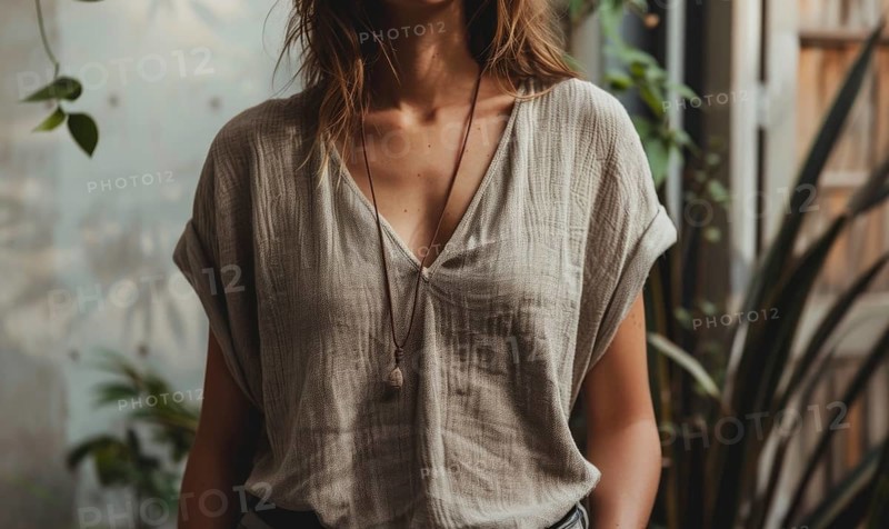 Woman in a simple linen shirt, bathed in natural light, surrounded by indoor plants AI generated