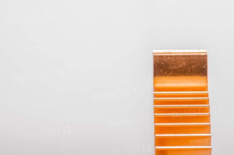 Closeup of copper computer heat sink fins on white background