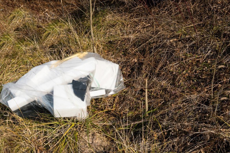 Broken and discarded polystyrene blocks litter a grassy field, in South Korea