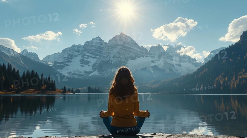 Woman meditating in front of a calm mountain lake at sunrise, relaxation, recreation, serenity, naturalness, meditation, enjoyment concept, AI generated