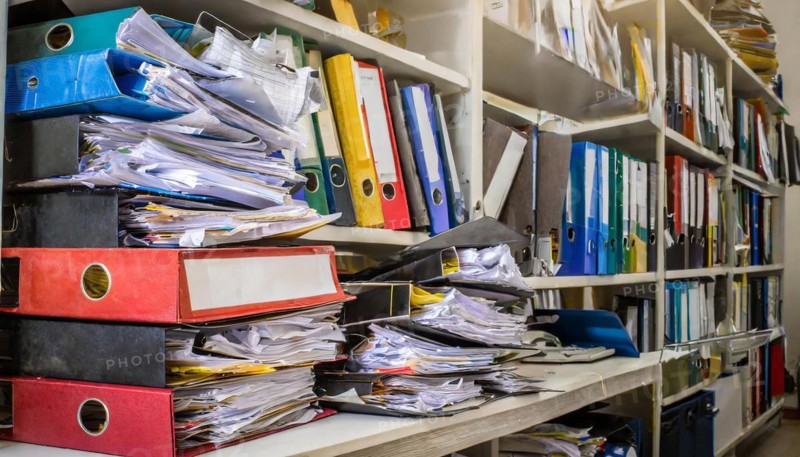 Many cluttered and chaotic files on shelves in an office, symbol bureaucracy, AI generated, AI generated