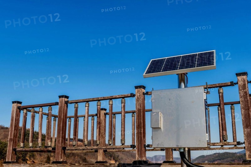 Single small solar panel on pole in front of wooden observation platform in Buan, South Korea, Asia