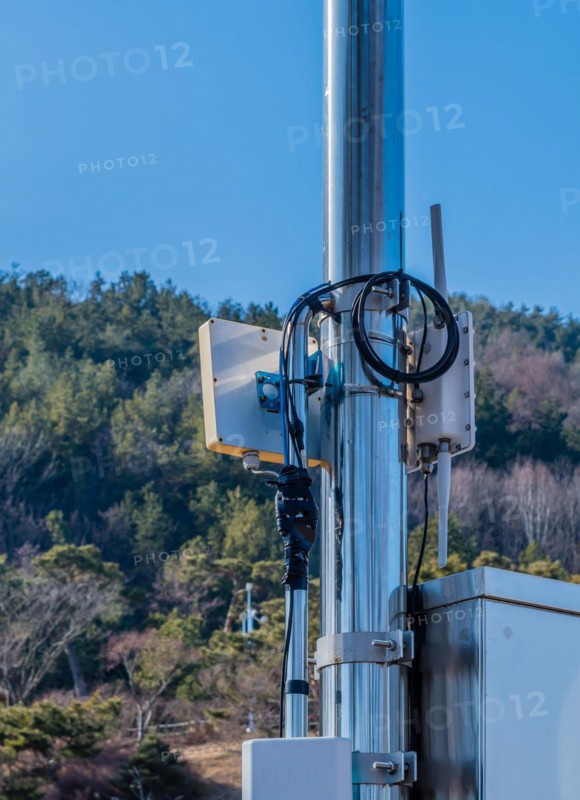 Closeup of coaxial cables from outdoor wireless router secured to meal pole using electrical tape in South Korea