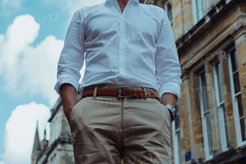 Midsection of a man in casual clothing standing on a city street, AI generated