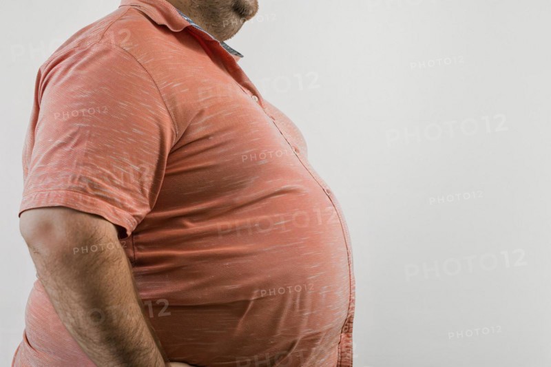 Close up of fat belly of heavily obese man in shirt on white background. KI generiert, generiert, AI generated