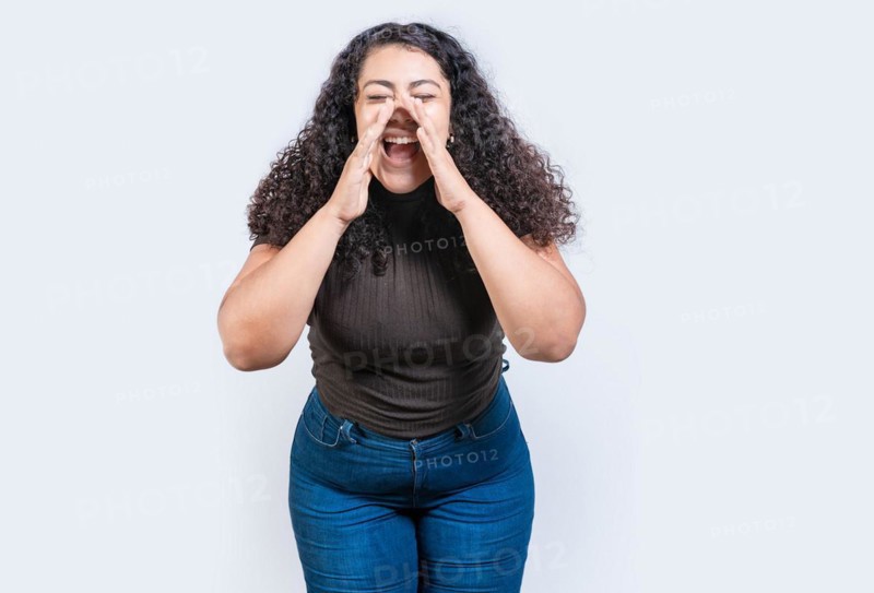 Beautiful girl announcing something to the camera isolated. Young girl screaming and announcing something at you