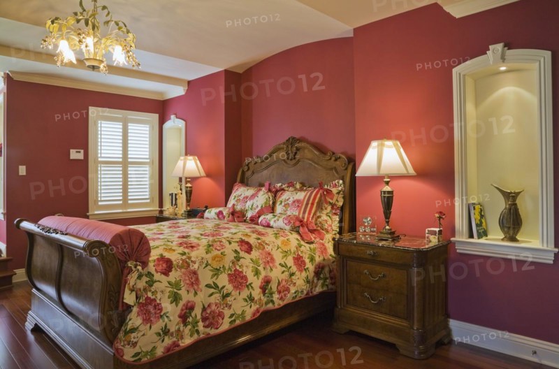 Wooden sleigh bed and night table in master bedroom on upstairs floor inside elegant style home, Quebec, Canada, North America