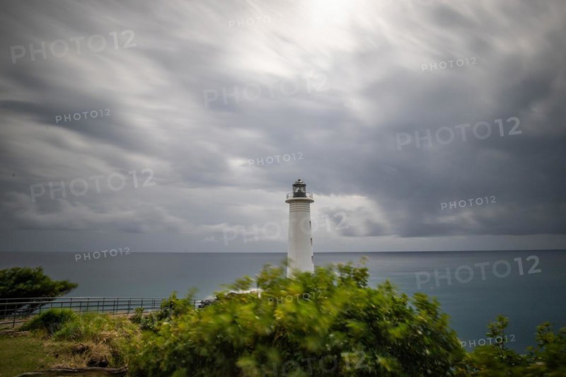 Le Phare du Vieux-Fort, white lighthouse on a cliff. Dramatic clouds with a view of the sea. Pure Caribbean on Guadeloupe, French Antilles, France, Europe