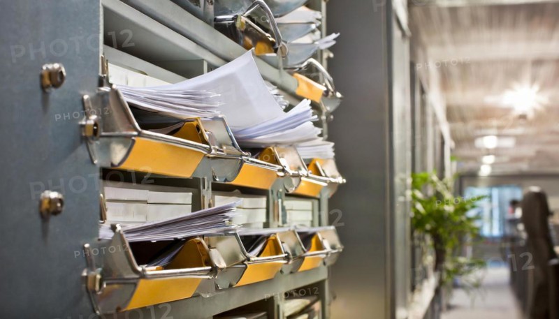 Wall mount with pockets full of documents and folders in an office, symbol bureaucracy, AI generated, AI generated