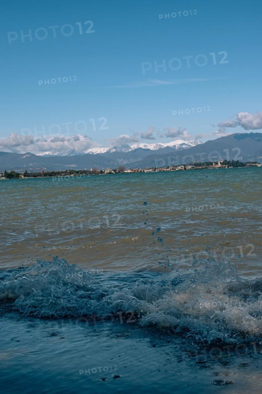 Splashing waves hitting the shore of Lake Garda, Sirmione, Lake Garda, Italy, Europe