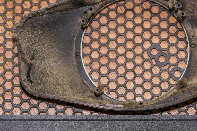 Close-up of a dusty electronic grille with a honeycomb pattern, in South Korea