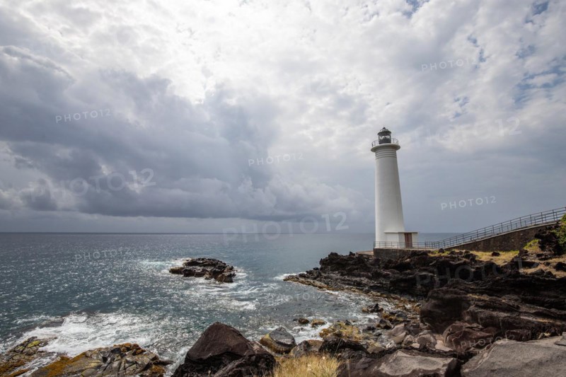 Le Phare du Vieux-Fort, white lighthouse on a cliff. Dramatic clouds with a view of the sea. Pure Caribbean on Guadeloupe, French Antilles, France, Europe